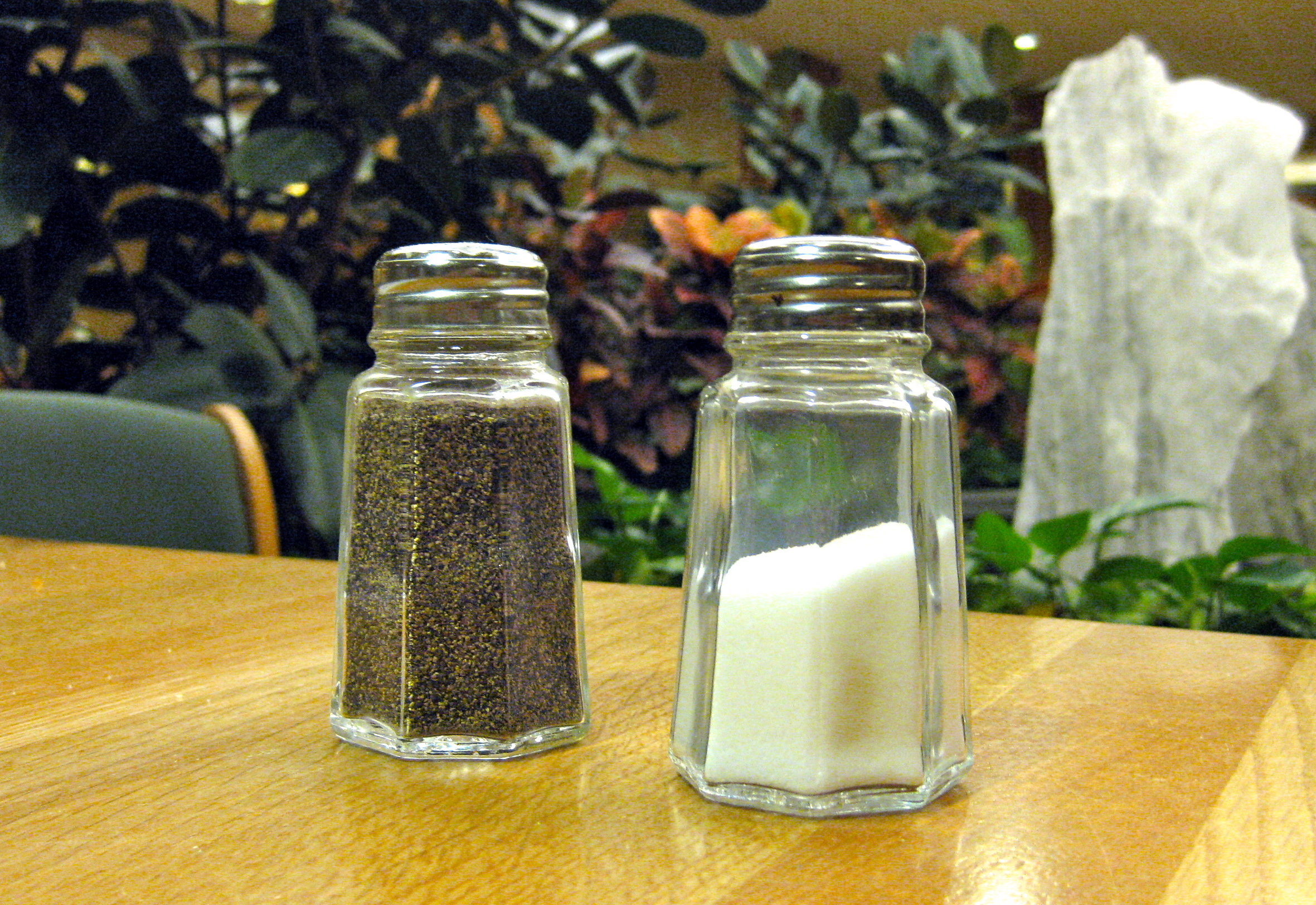 Salt and pepper shakers on a table.